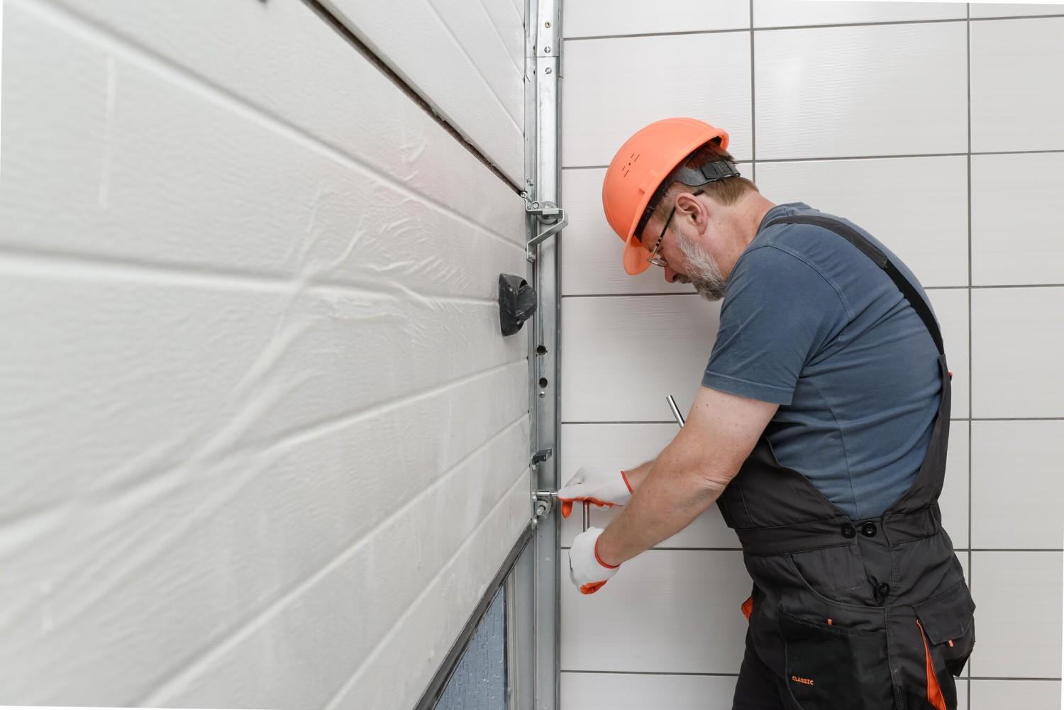 Technician inspecting a garage door panel