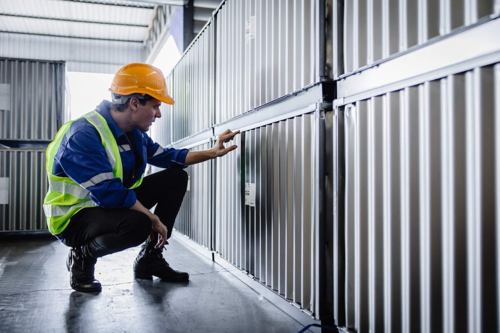 Technician inspecting a commercial roll-up door